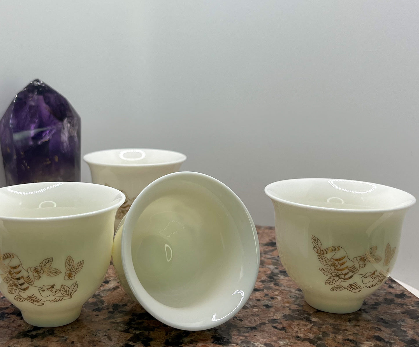 Set of Four 50ml Crouching Tiger Tea Cups with design displayed, one tea cup is on its side to display the depth of the tea cup